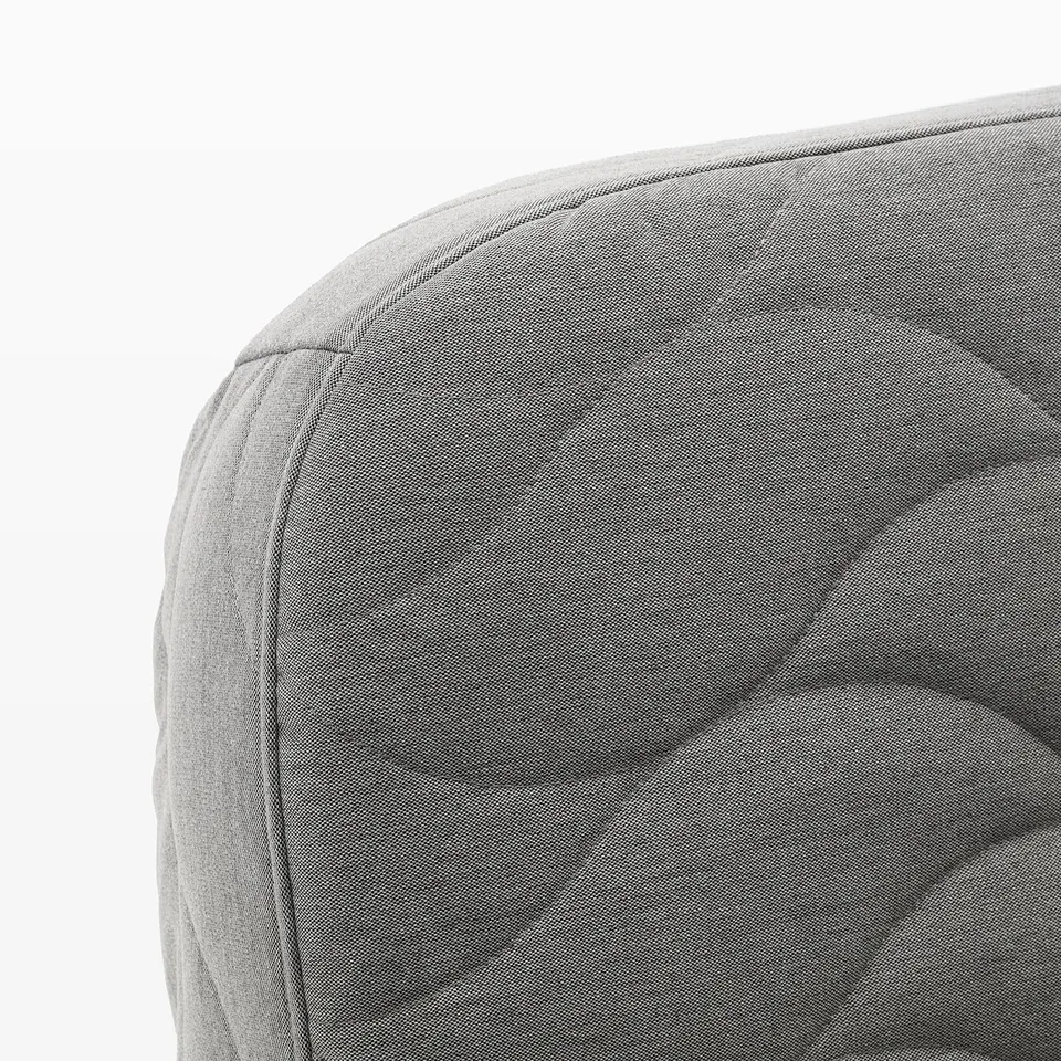 Close-up of modern, grey upholstered furniture corner, showcasing quality fabric and stitching.