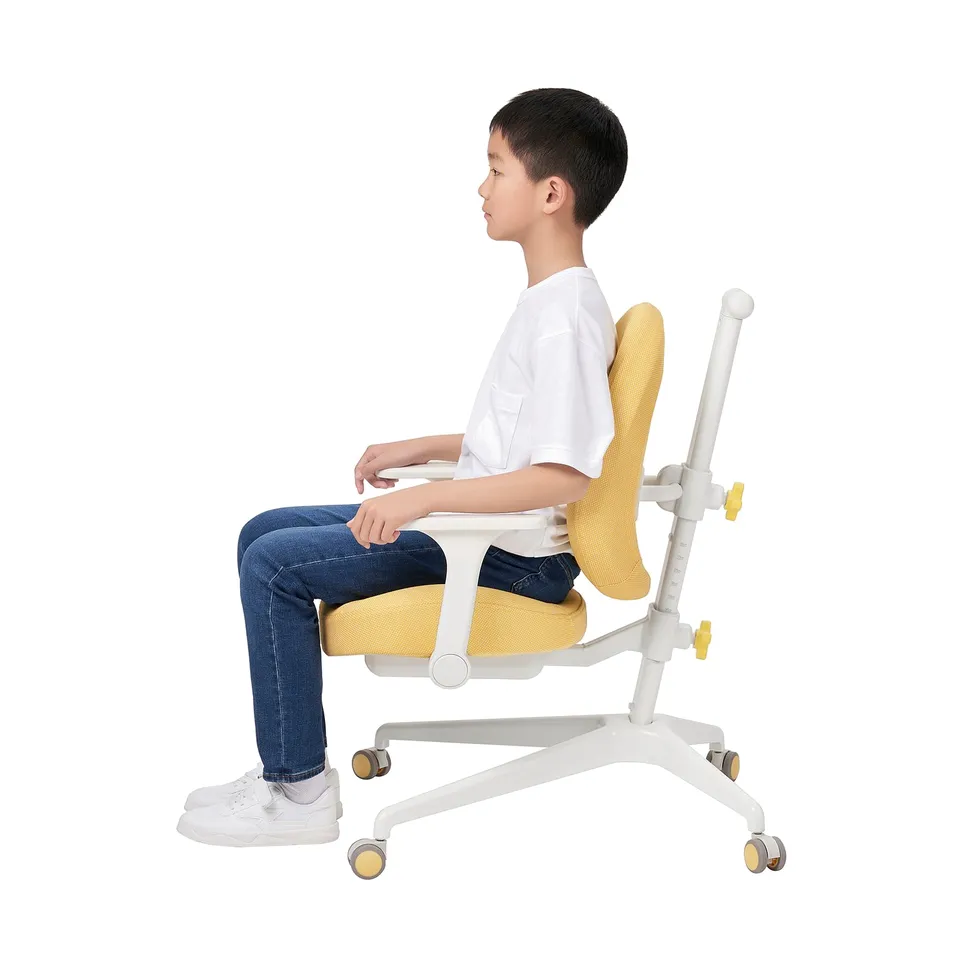 Boy sitting on adjustable desk chair with back support, padded seat, and armrests.