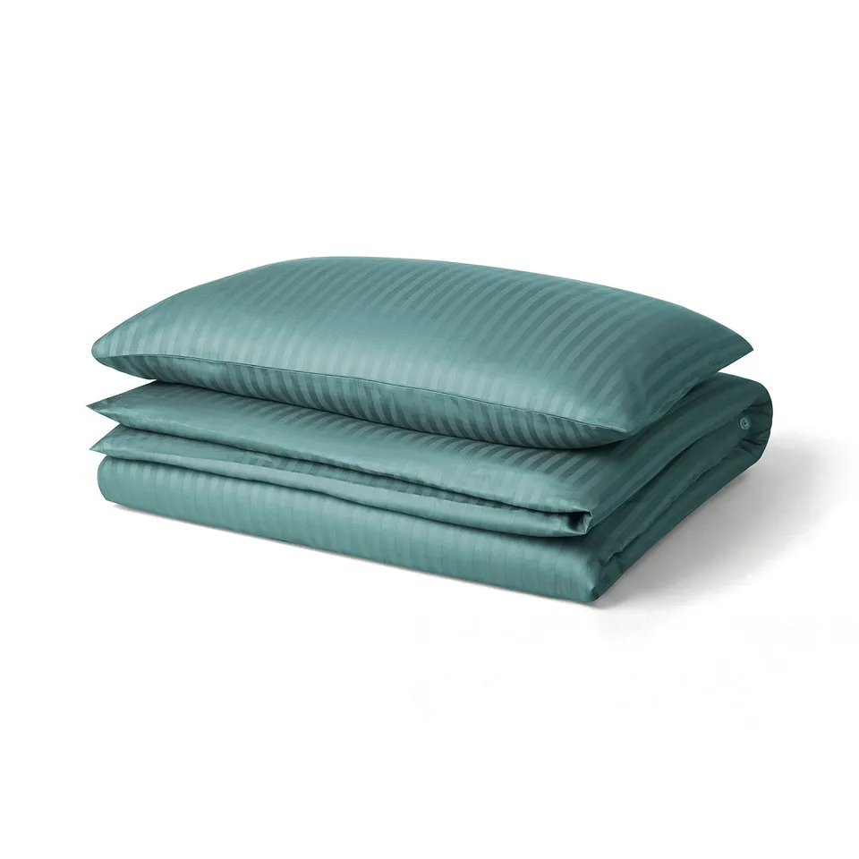 Folded green duvet set with striped pattern, smooth texture, button closure.