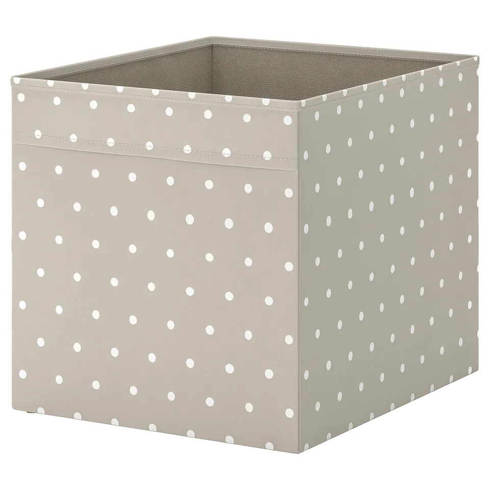 Polka-dotted fabric storage box, beige with white dots, square, for shelving.