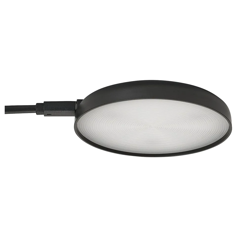 The STRIMSÄV spotlight in black. Flat, round shape, its ideal for illuminating cabinets.