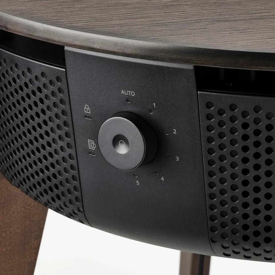 Modern air purifier side table with sleek controls, smooth surface, and perforated speaker-style design for efficient, stylish ventilation.