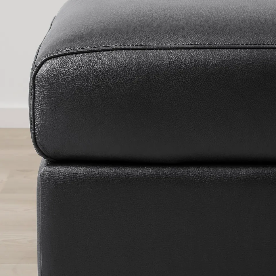 Black leather furniture section. Sleek, modern design. High-quality, smooth grain leather.