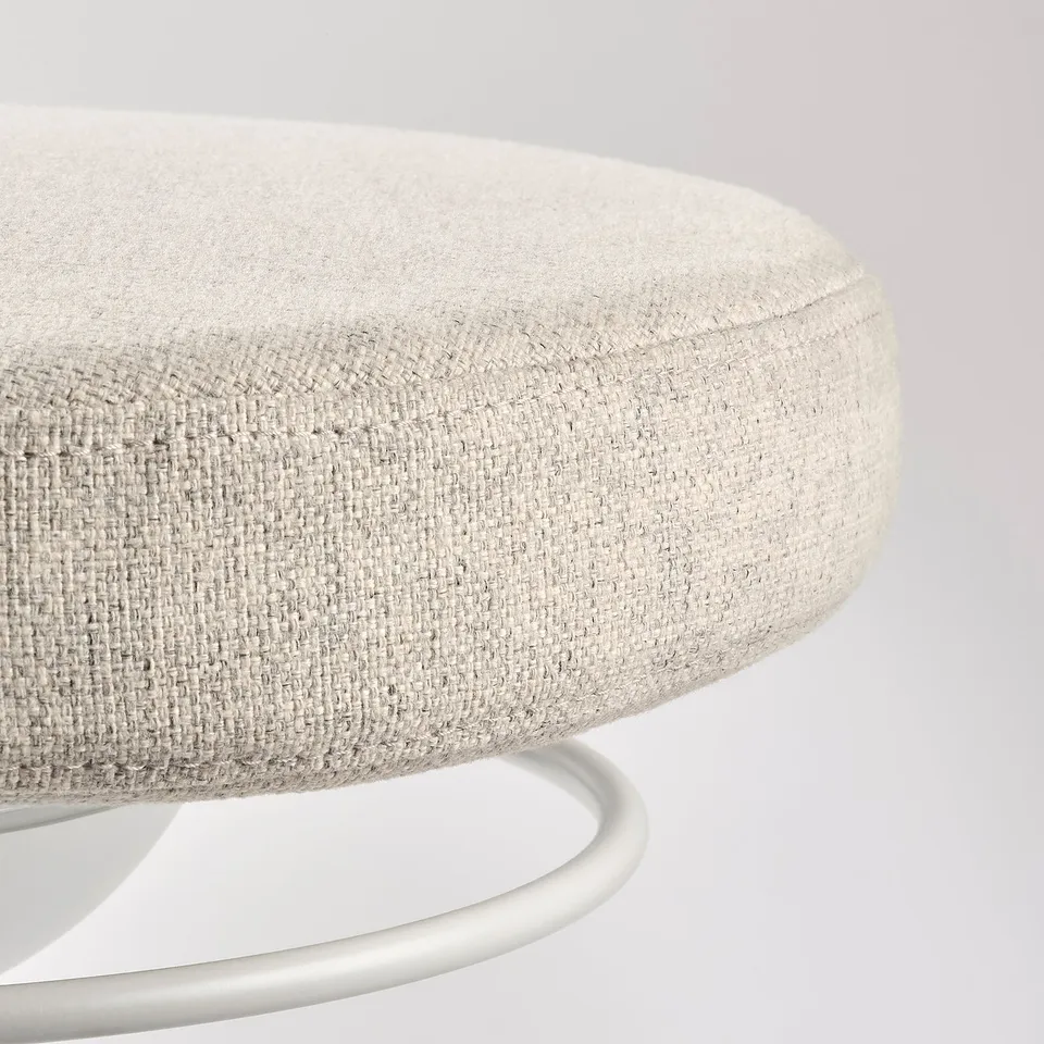 Round, upholstered stool with shiny metallic base.