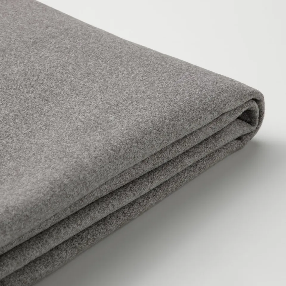 Soft, folded grey fabric, likely sofa cover, high-quality felted texture.
