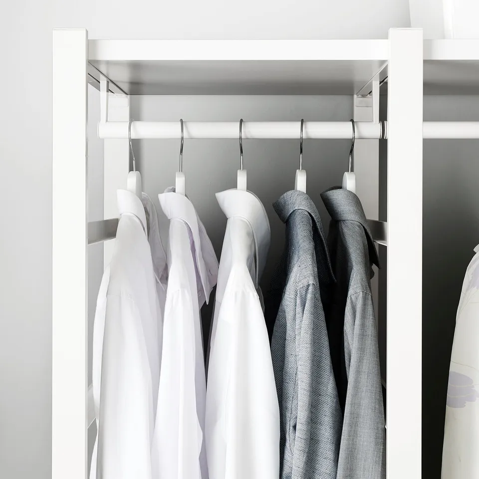 Closet with white ELVARLI rail, hanging shirts, and sweater; neat organisation.