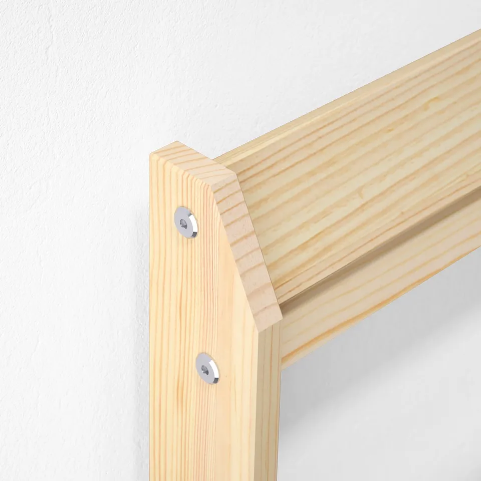 Wooden bed frame corner, showing quality craftsmanship with solid pine and metal hardware.