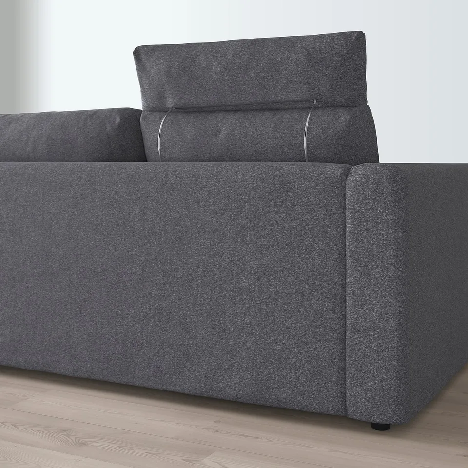 Grey sofa with detachable, washable cover and extended headrest for neck support.
