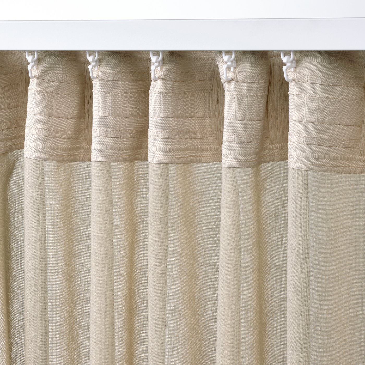 Sheer beige curtains hang with white tabs, filtering light, offering privacy, and suitable for wide windows or room dividers.