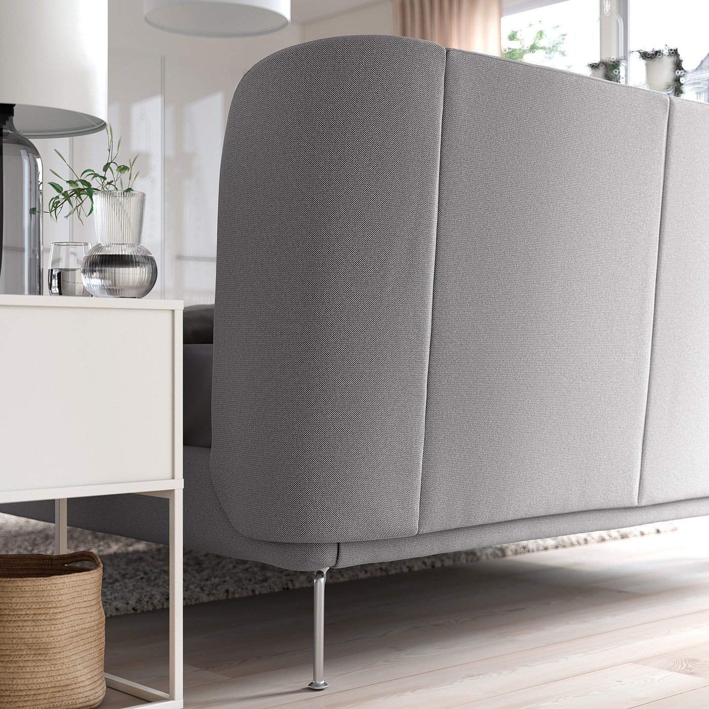 Modern bed with curved grey headboard, adjustable sides and under-bed storage.