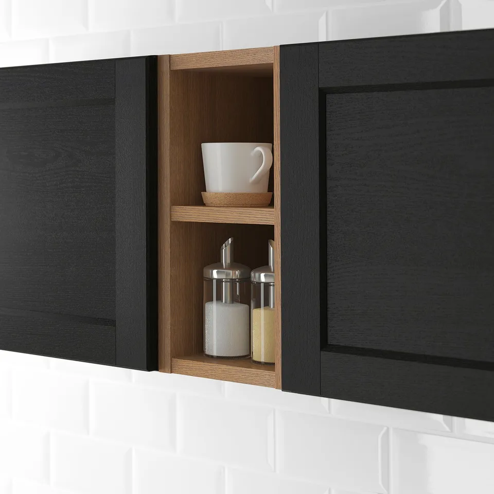 Black kitchen open cabinet displaying items. Wooden shelves with a white mug, salt, and pepper shakers.