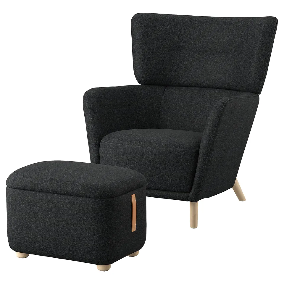 Dark grey OSKARSHAMN chair & ottoman set. Soft, high-back design with wooden legs. Includes fabric-covered storage footstool.