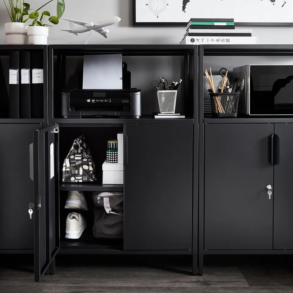 Modern black office cabinet with secured lock storage, open shelves for printer and supplies, and adjustable feet for stability.