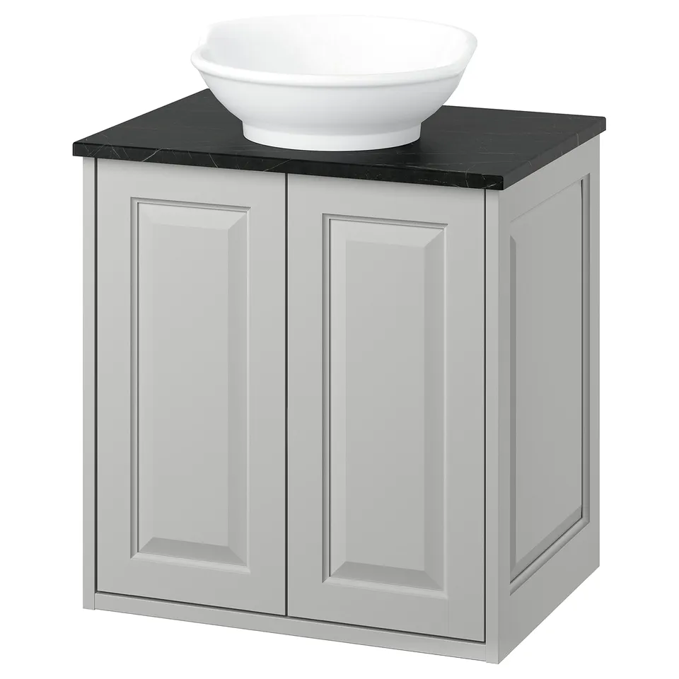 White TÄNNFORSEN bathroom cabinet with black counter and bowl sink.
