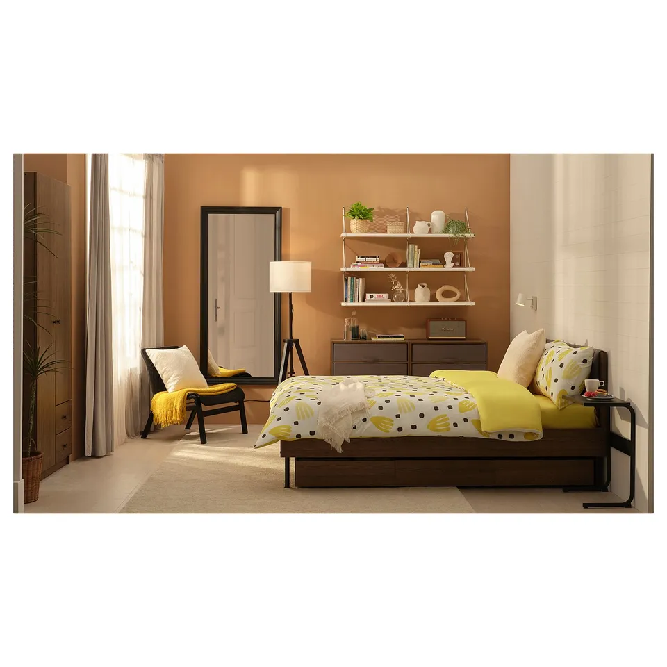 Bedroom with BRUKSVARA yellow bedding set, wooden furniture, shelves, and floor lamp.