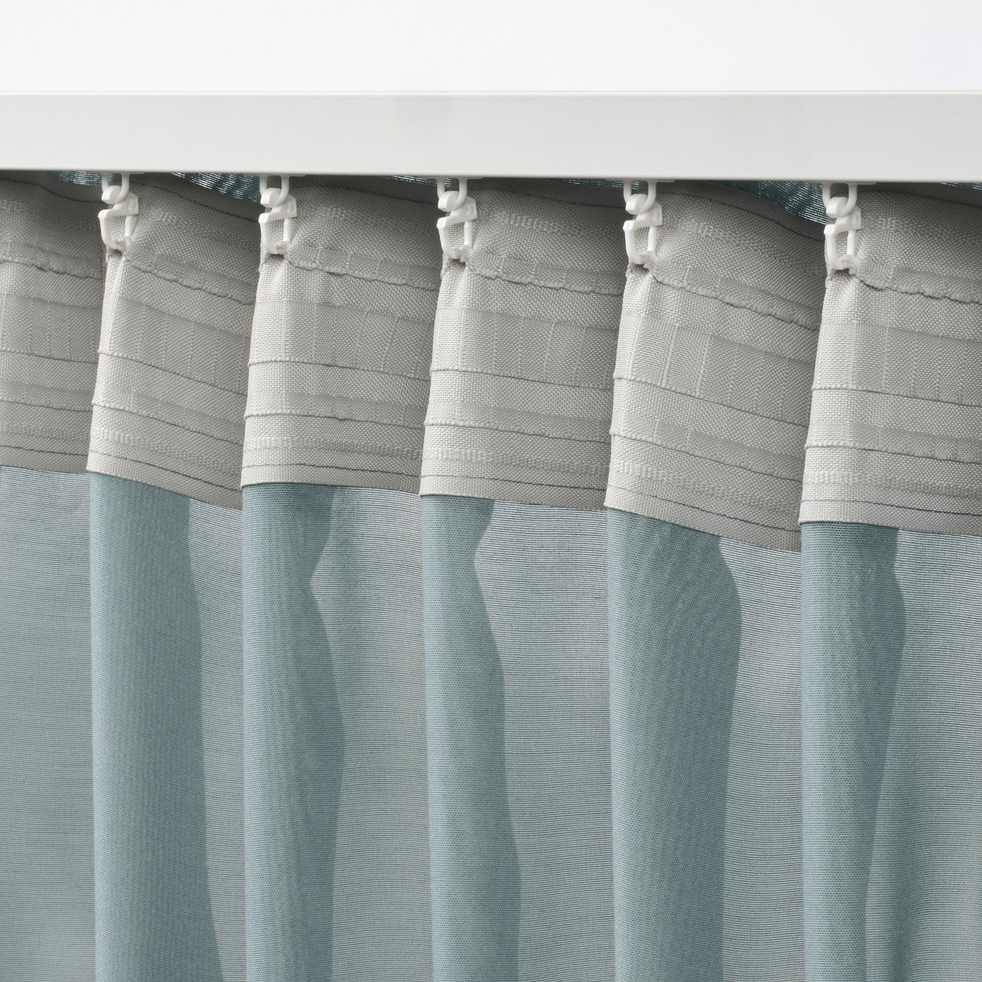 Close-up of STENFRÖ curtains heading tape with hooks, designed for easy pleat creation.