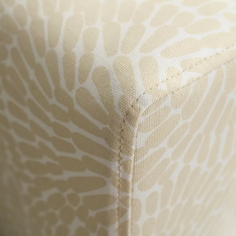 Close-up of SALTSJÖBADEN sofa corner: soft, quality fabric with intricate floral print, securely stitched.