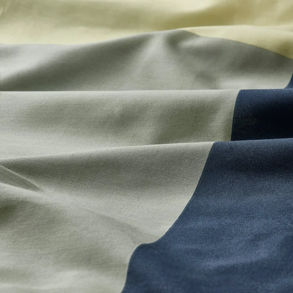 Soft fabric close-up, showing smooth texture and intricate weave, likely a high-quality cotton blend.