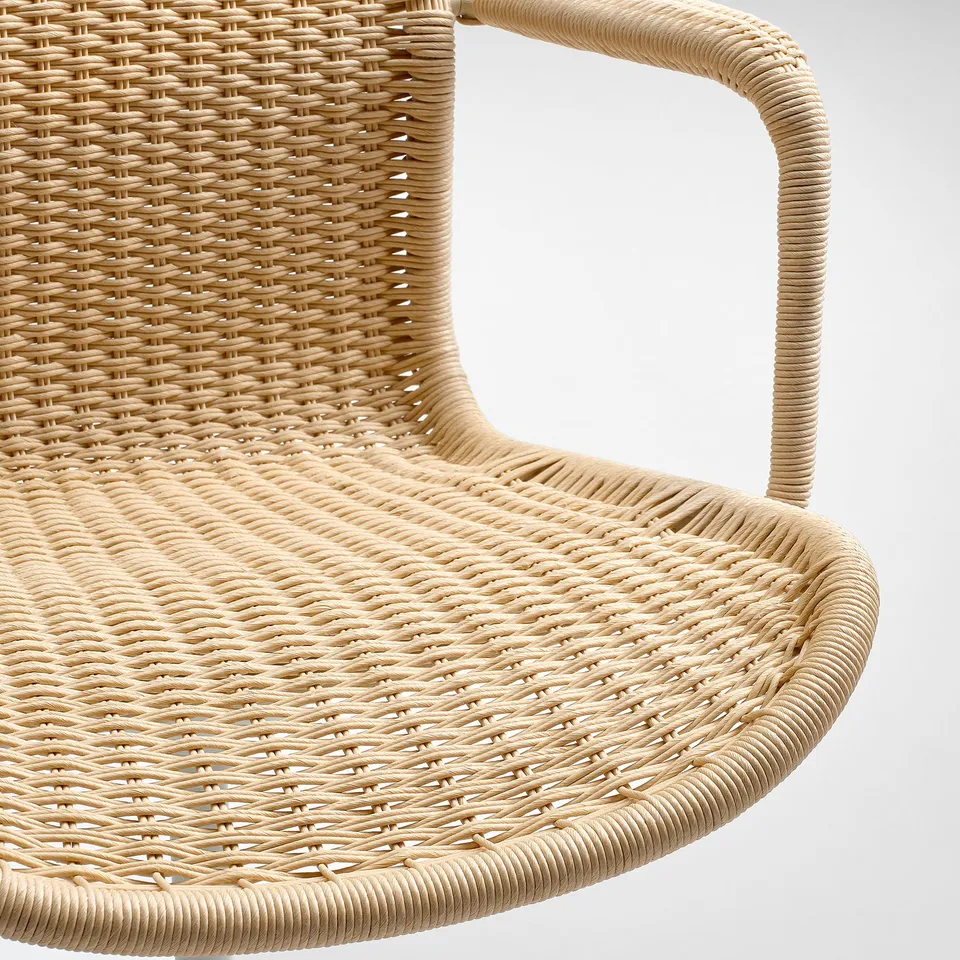 Close-up of woven chair detail, showing intricate, handwoven paper twine. Highlights quality craftsmanship and natural texture.