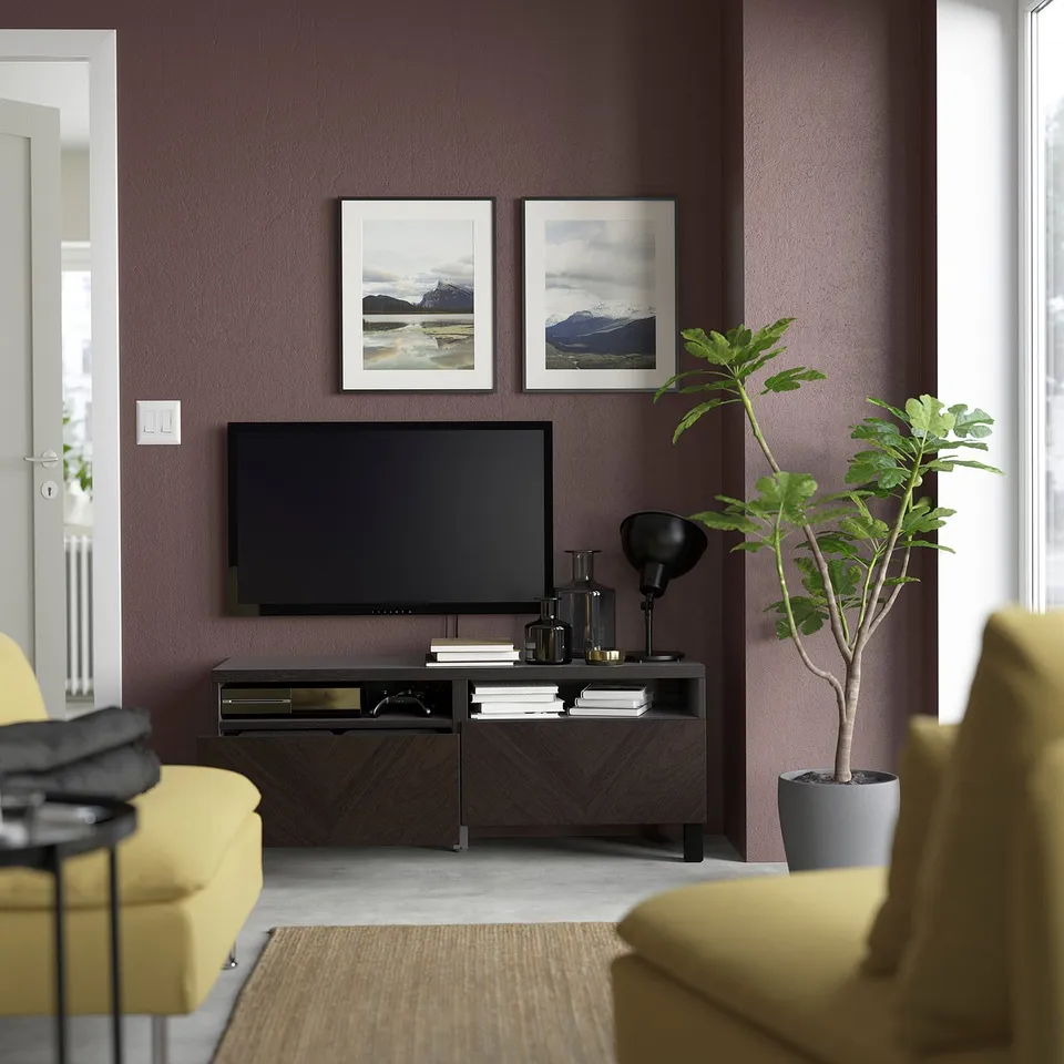 Modern living room with BESTÅ tv unit, yellow chairs, and flat-screen tv.