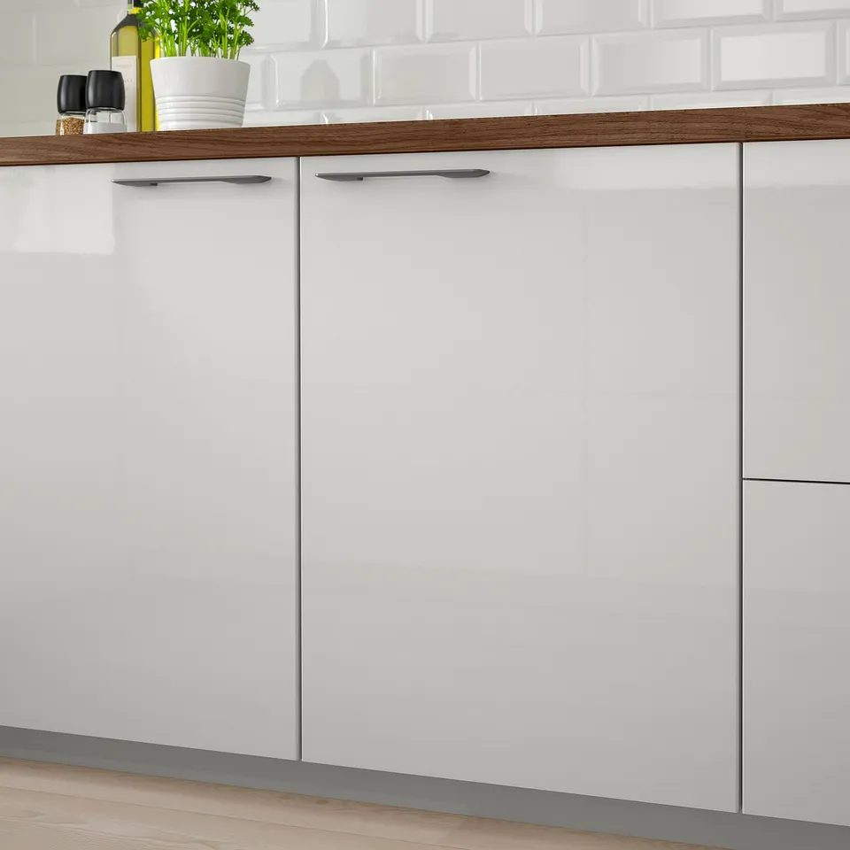 Modern kitchen cabinets with high-gloss white finish, featuring sleek design and easy-clean surfaces.