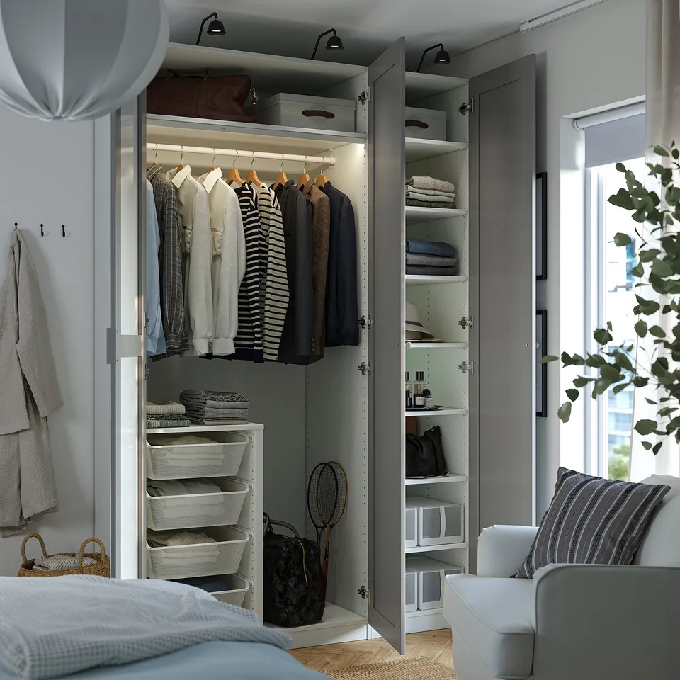 Modern wardrobe with lit clothes storage, polished hanging rails, and organised shelves.