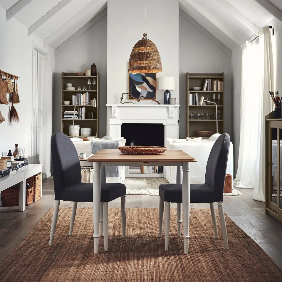 Grey chairs around DANDERYD table in bright living room, large window.