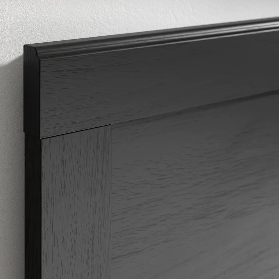 Dark wood-paneled furniture corner, showcasing sleek, polished finish, highlighting refined design detail.