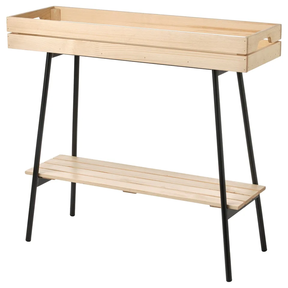 Wooden plant stand with black metal legs.