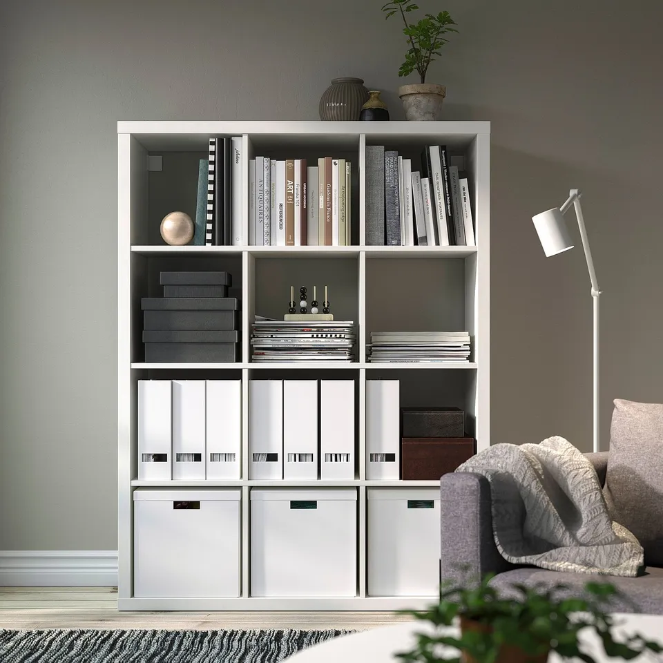 KALLAX shelf with books, boxes, lamp, chair, wide & tall.
