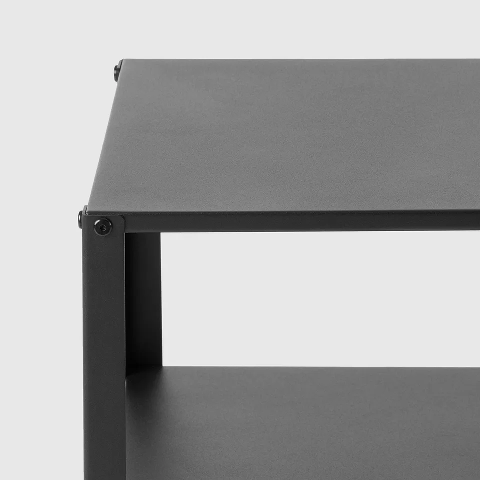 Modern black metal bedside table with sleek, flat top and open shelf for storage, assembled simply with clean lines.