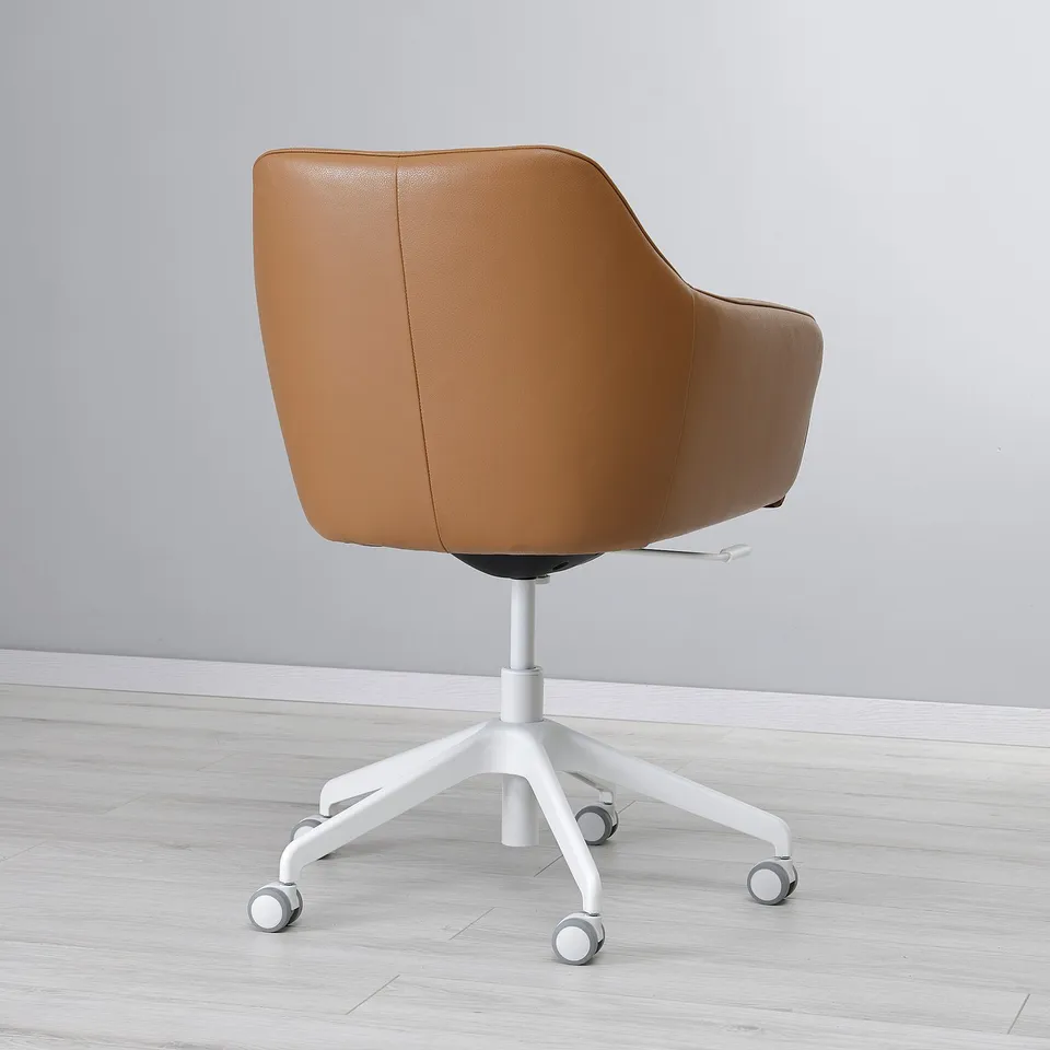 Chair with brown leather, white base, and castors. Upholstered, padded for comfort.