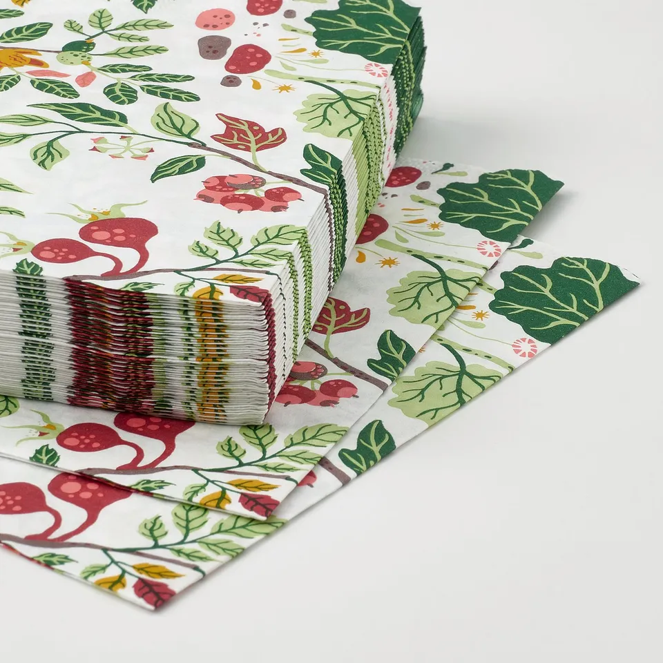 Noticeable stack of decorative napkins, colourful floral pattern, high-quality multi-ply design.