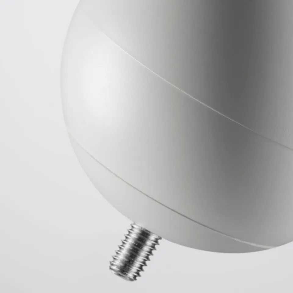 Close-up of modern, matte white spherical finial with threaded attachment.