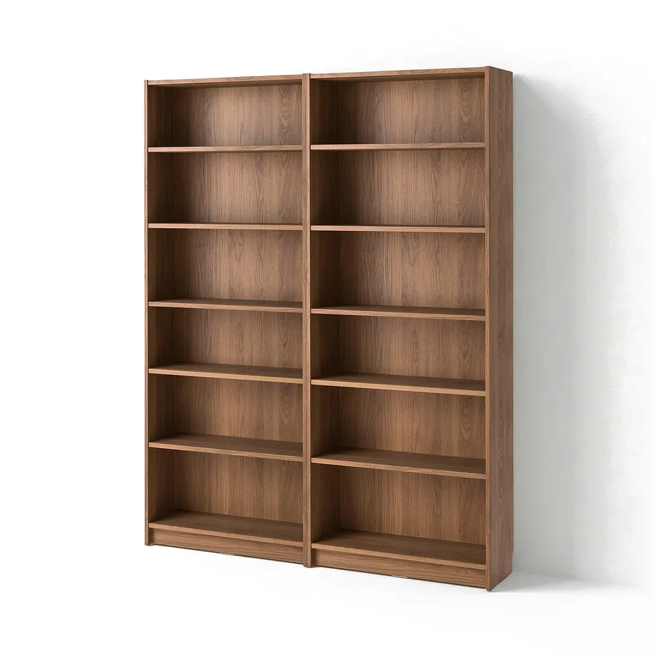 Two tall, empty wooden bookcases in light brown, with multiple shelves, standing against a white wall.