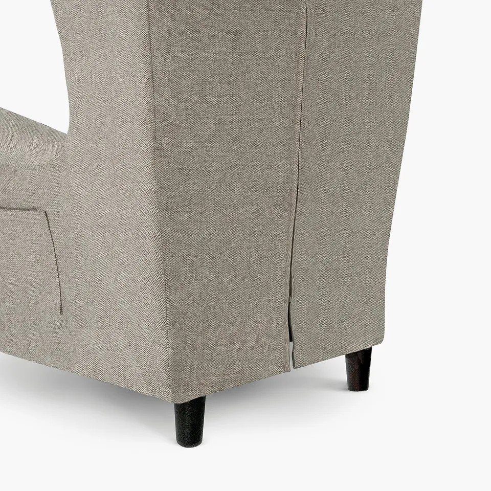 Grey fabric armchair with dark wooden legs, featuring a zip for easy cover removal.