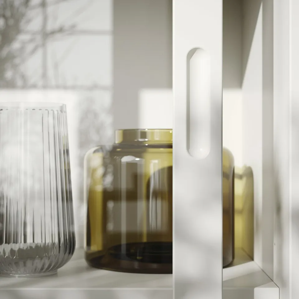 White cabinet with textured glass, smooth glass jars on shelf.