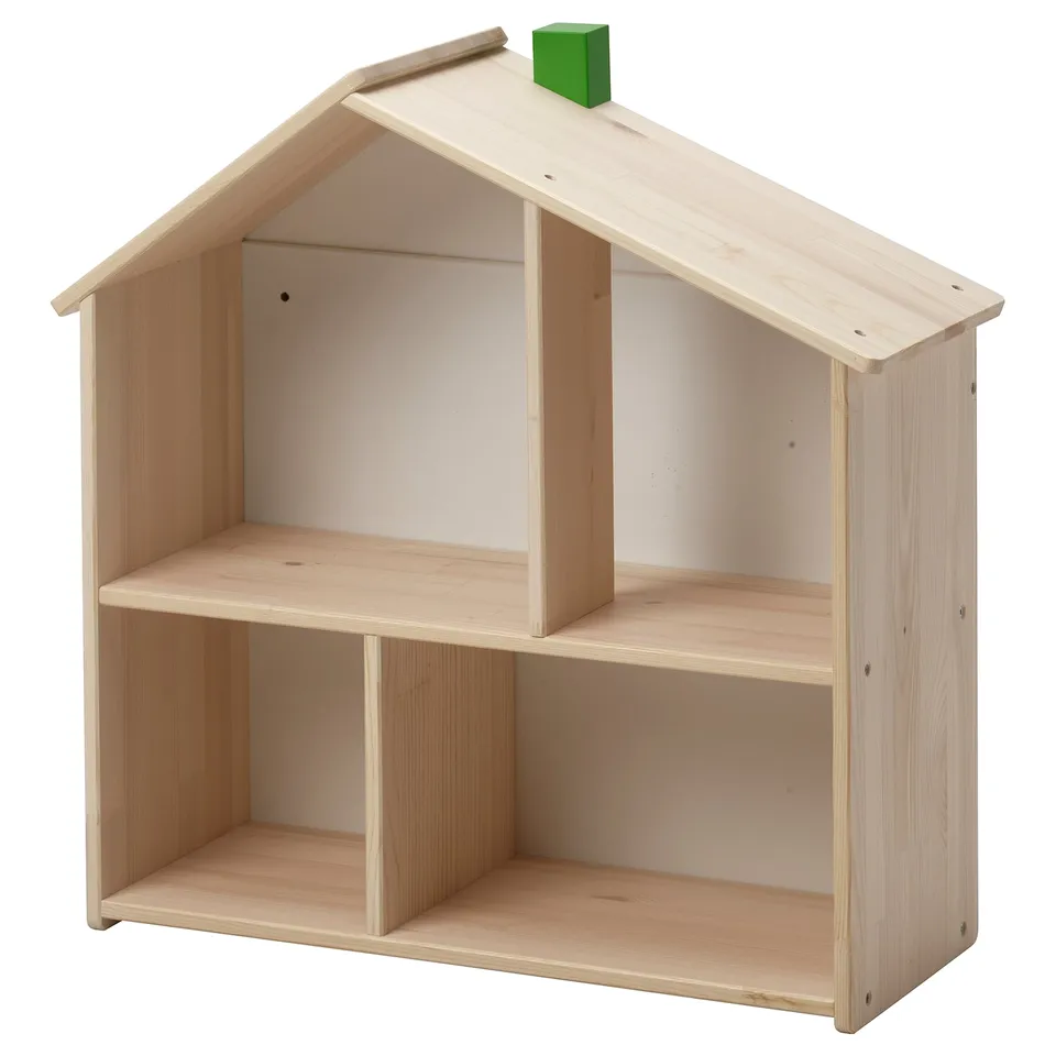 A light wooden toy house shelf in natural wood. It has an open design with multiple compartments and a pitched roof. The top a small green chimney.