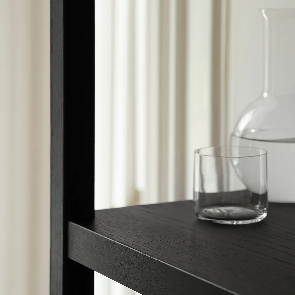 Wood shelf with jar & cup by window.
