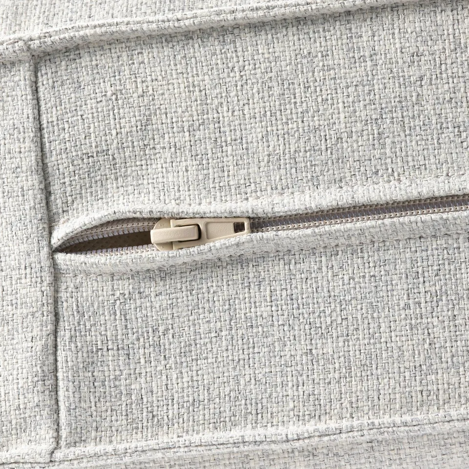 Close-up of KIVIK sofa zip, showcasing robust, textured fabric and sturdy zip detail.
