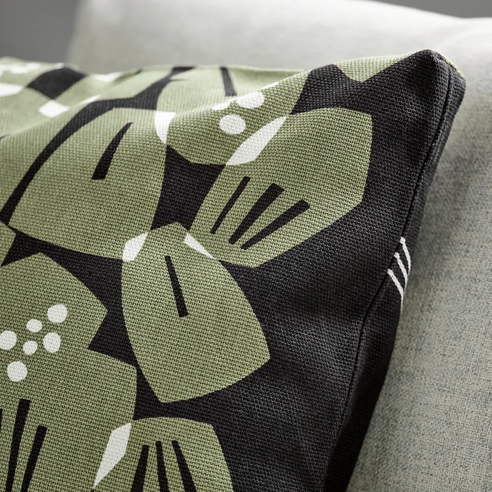 Pic: modern cushion with abstract green leaf print, thick texture, zip closure.