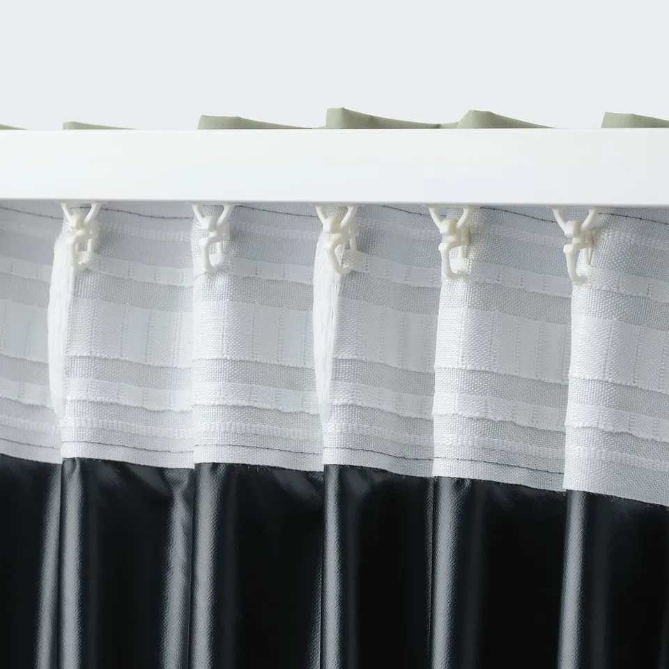 White curtain with loops hanging, featuring a textured pattern. It blocks light and can be cut to length without shredding.
