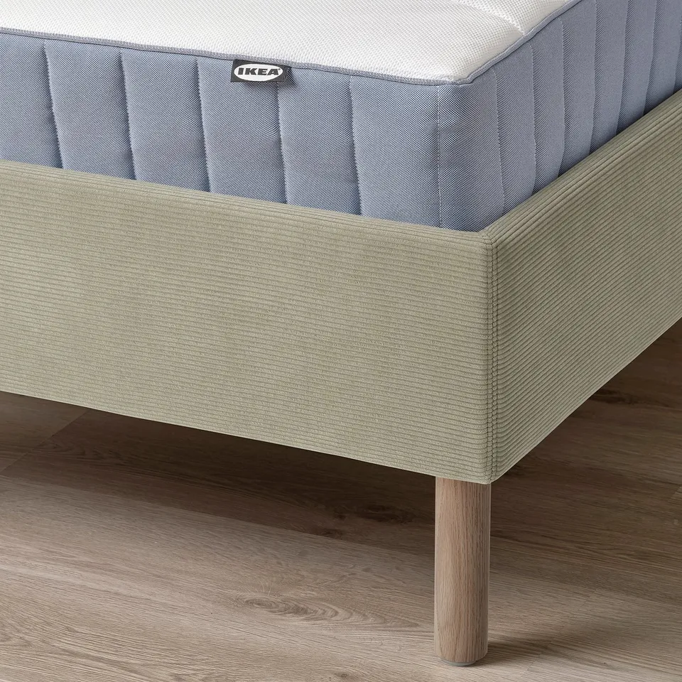 IKEA TÄRNKULLEN bed frame with padded headboard, light wood legs, and washable cover.