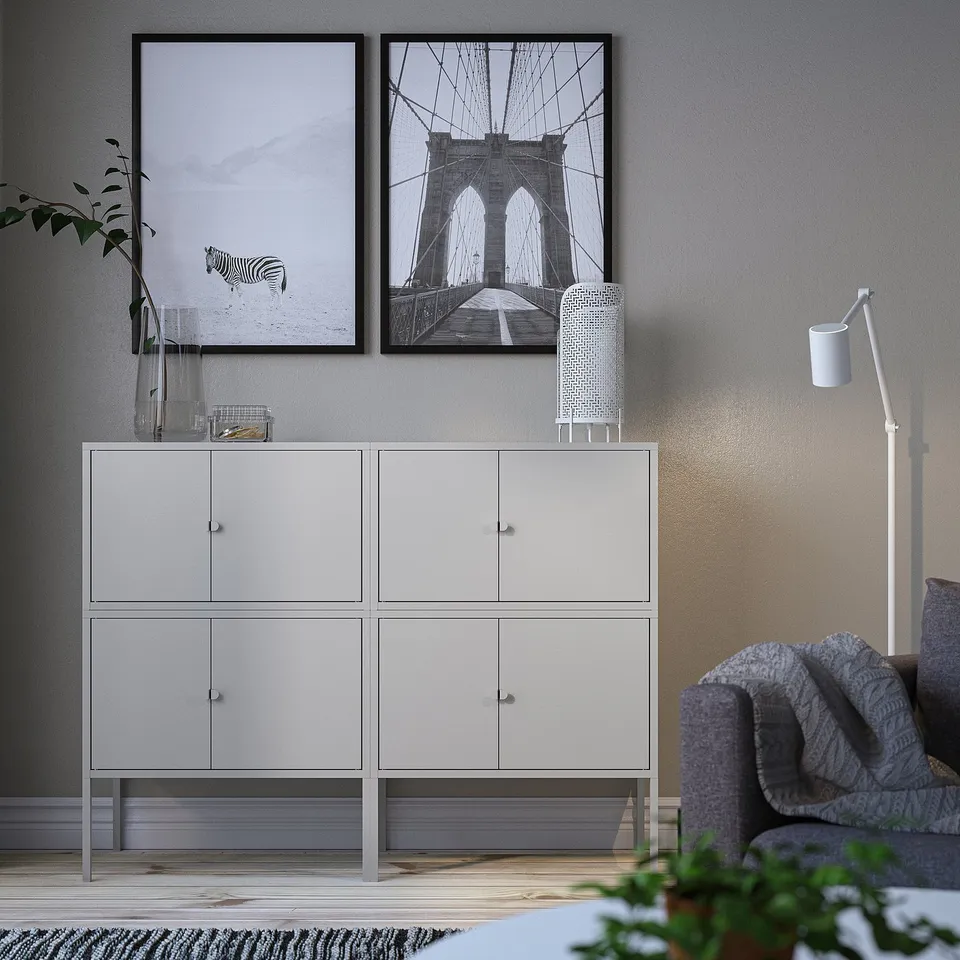 Modern living space with white LIXHULT cabinet, zebra & brooklyn bridge art.