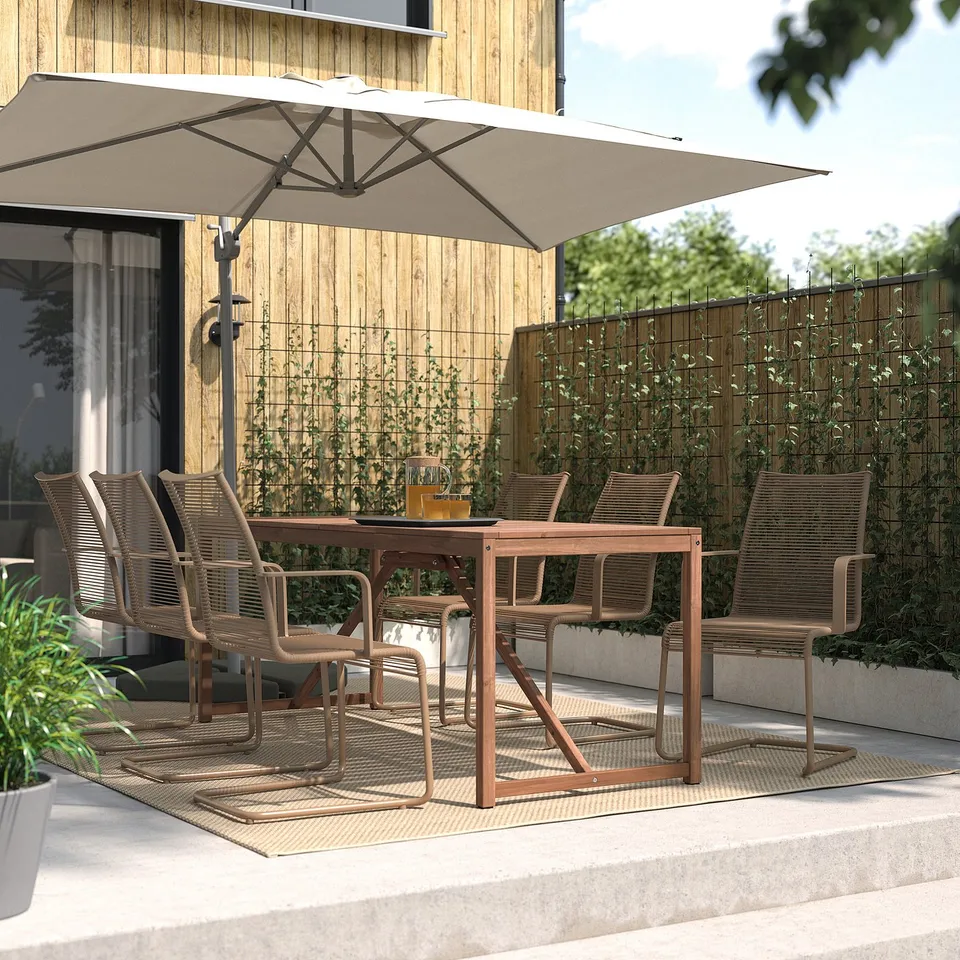 Outdoor patio set with table, chairs, umbrella. Acacia wood, beige, rectangular. Spacious for six.