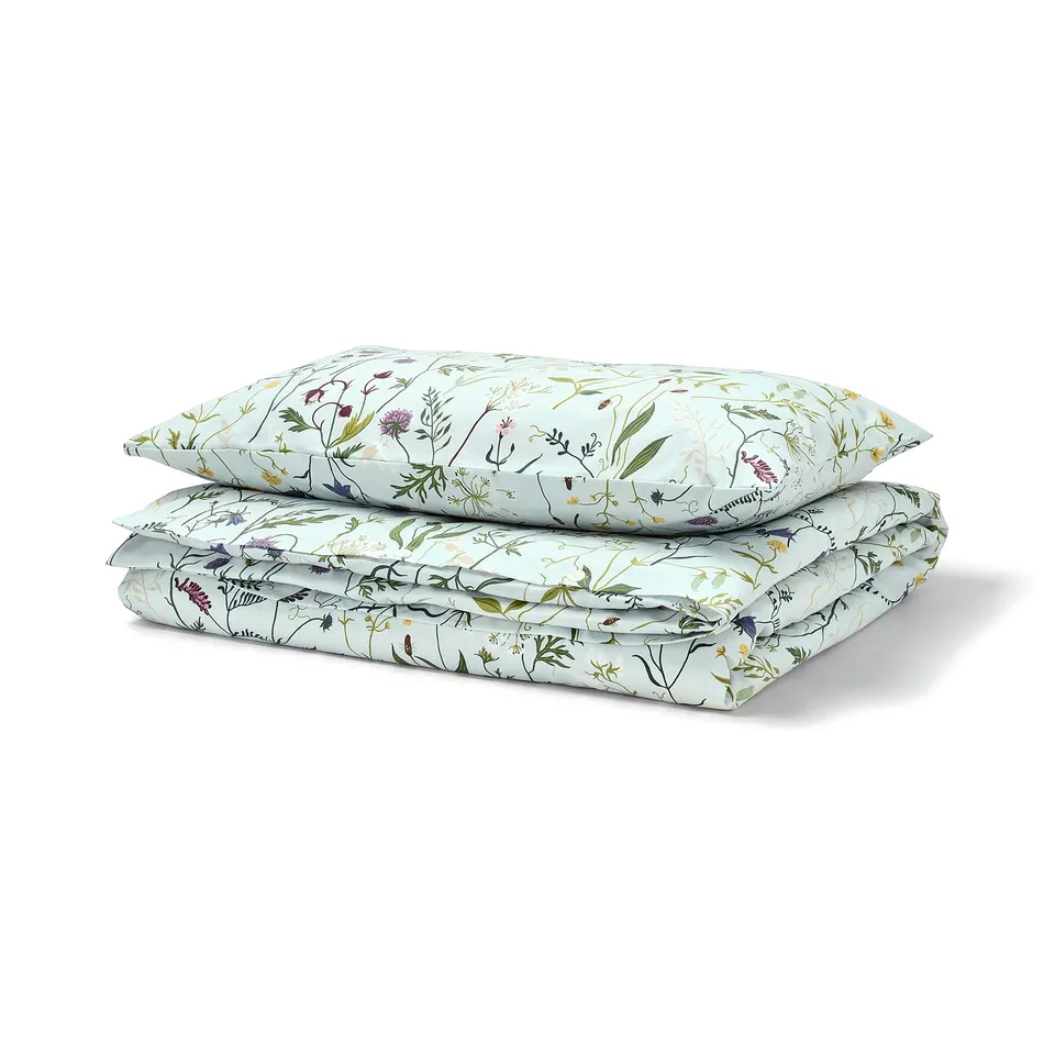 Light blue MATTOXBÄR bedding set featuring floral design, folded neatly, made from soft 100% cotton.