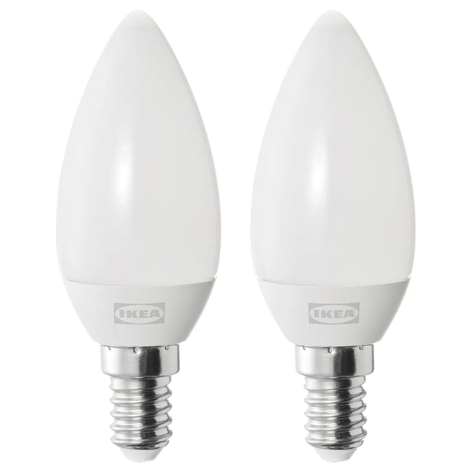 Two ikea led bulbs, white with frosted covers, cylindrical base, silver threads, brand logo visible.