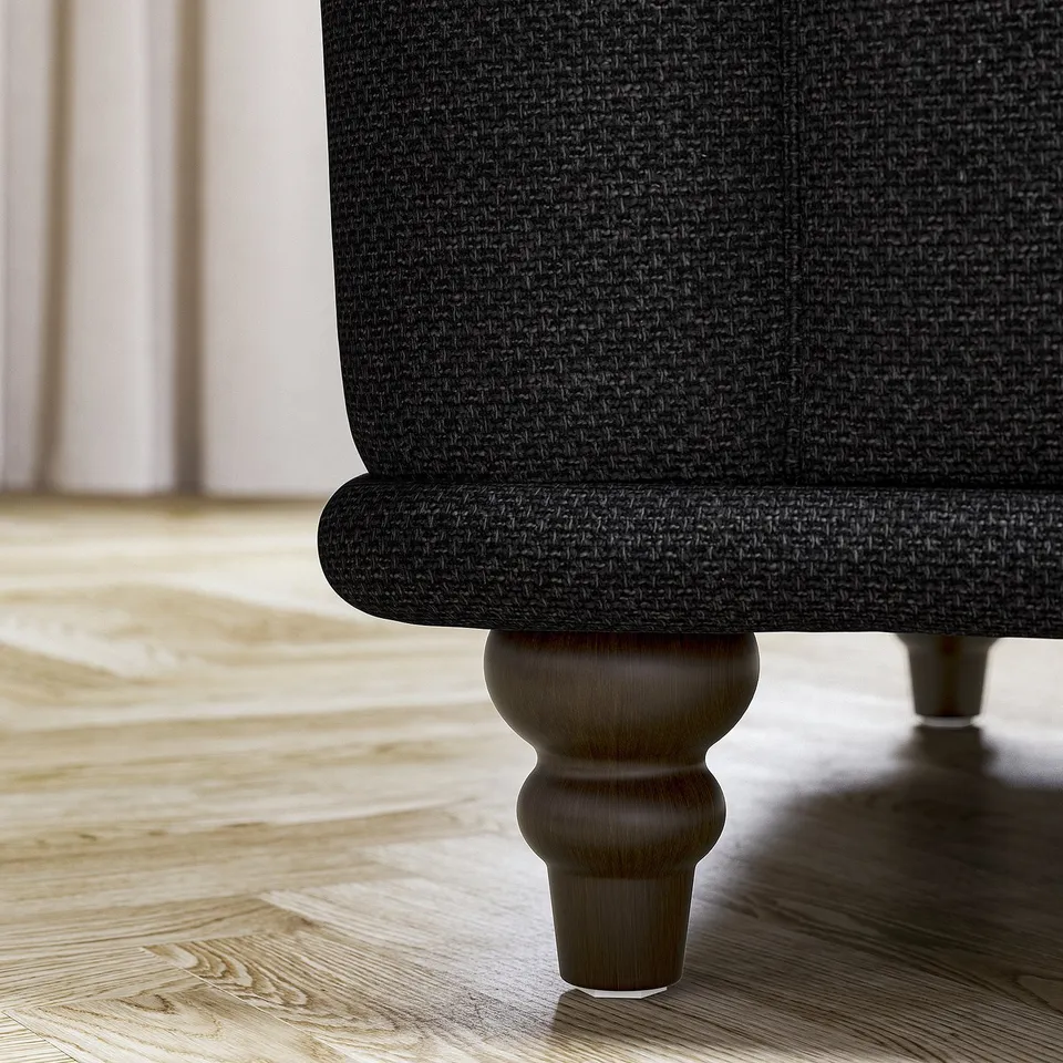 Dark fabric sofa with curved wooden legs.