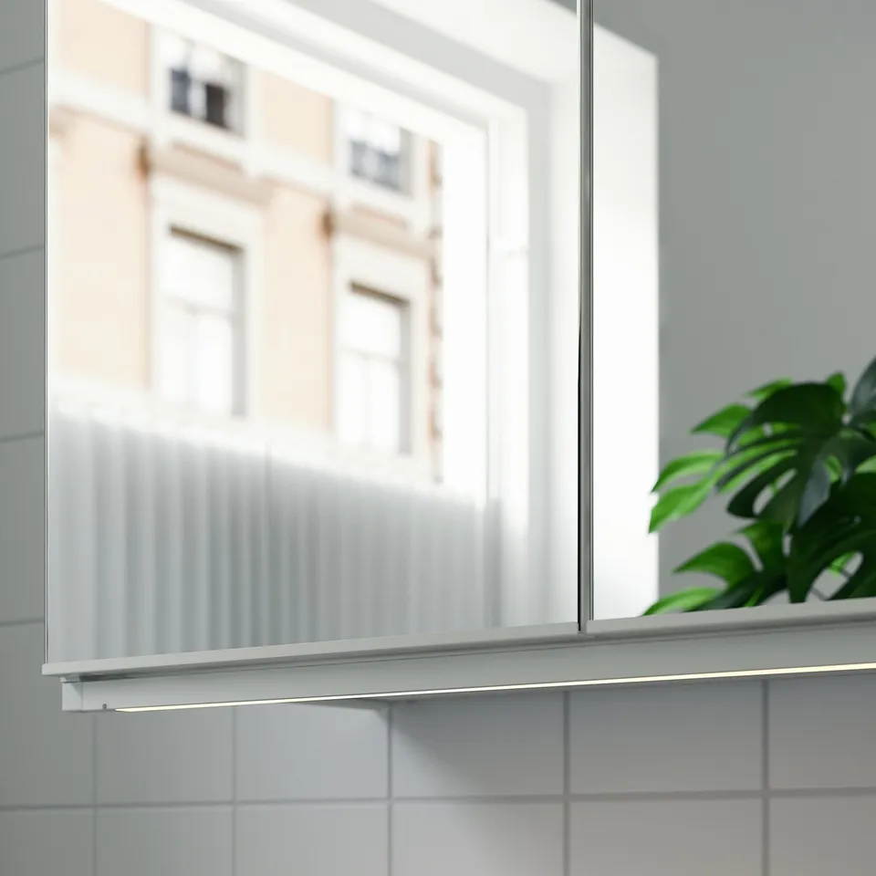 Bathroom mirror with led lights and plant.