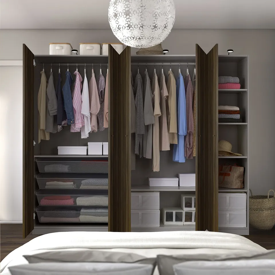Organised walk-in closet with hangers, shelves, ample space, and built-in lighting.